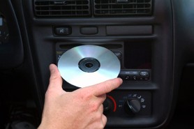 Man Inserting CD in Stereo